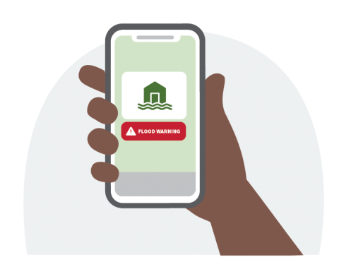 A hand holding a smartphone displaying a flood warning notification with a symbol of a flooded house and an alert label that says 'FLOOD WARNING.