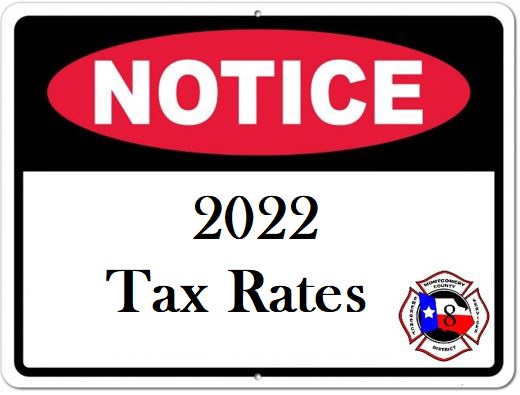 Sign with a red oval labeled NOTICE on a black background. Below, it reads 2022 Tax Rates on a white background. There is an emblem on the bottom right with a star and shield.