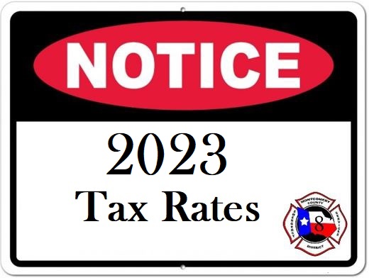 A notice sign displaying 2023 Tax Rates in bold text. The word NOTICE is highlighted in red at the top. A logo featuring a star and fire department emblem is located in the bottom right corner.