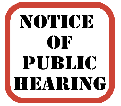 A white sign with a red border reads NOTICE OF PUBLIC HEARING in bold, black, uppercase letters.